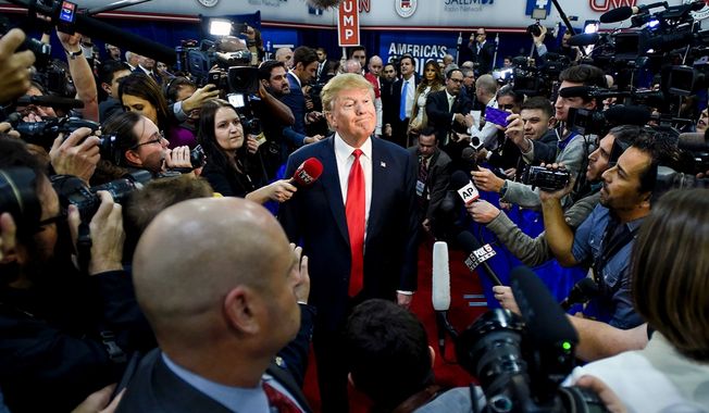 The ever-present media: Then Republican presidential hopeful Donald Trump is surrounded by the press while on the campaign trail in 2016, seen here at a stop in Las Vegas, Nev.    (Associated Press)
