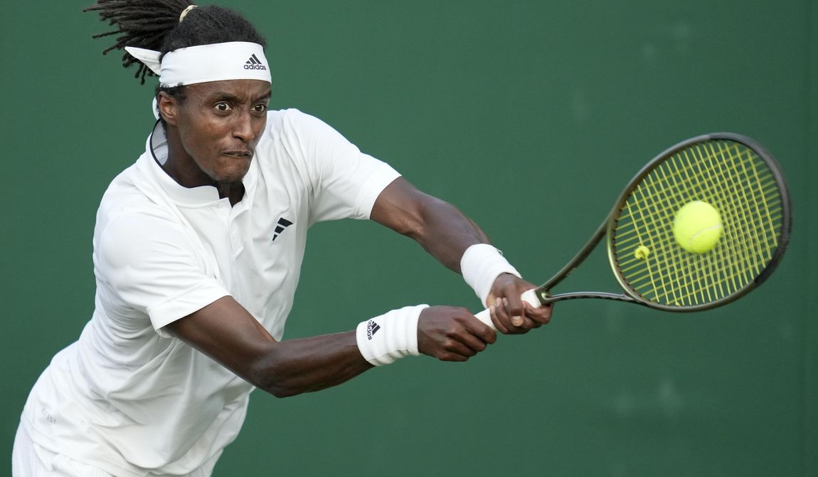 Sweden&#x27;s Mikael Ymer returns to Colombia&#x27;s Daniel Elahi Galan in a men&#x27;s singles match on day five of the Wimbledon tennis championships in London, Friday, July 7, 2023. (AP Photo/Kin Cheung)