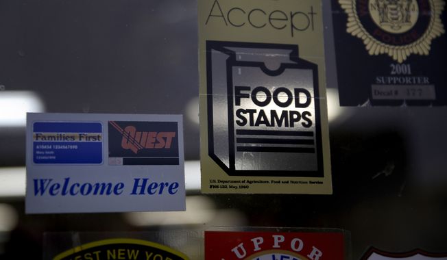 In this Jan. 12, 2015, photo, a supermarket displays stickers indicating they accept food stamps in West New York, N.J. (AP Photo/Seth Wenig) **FILE**